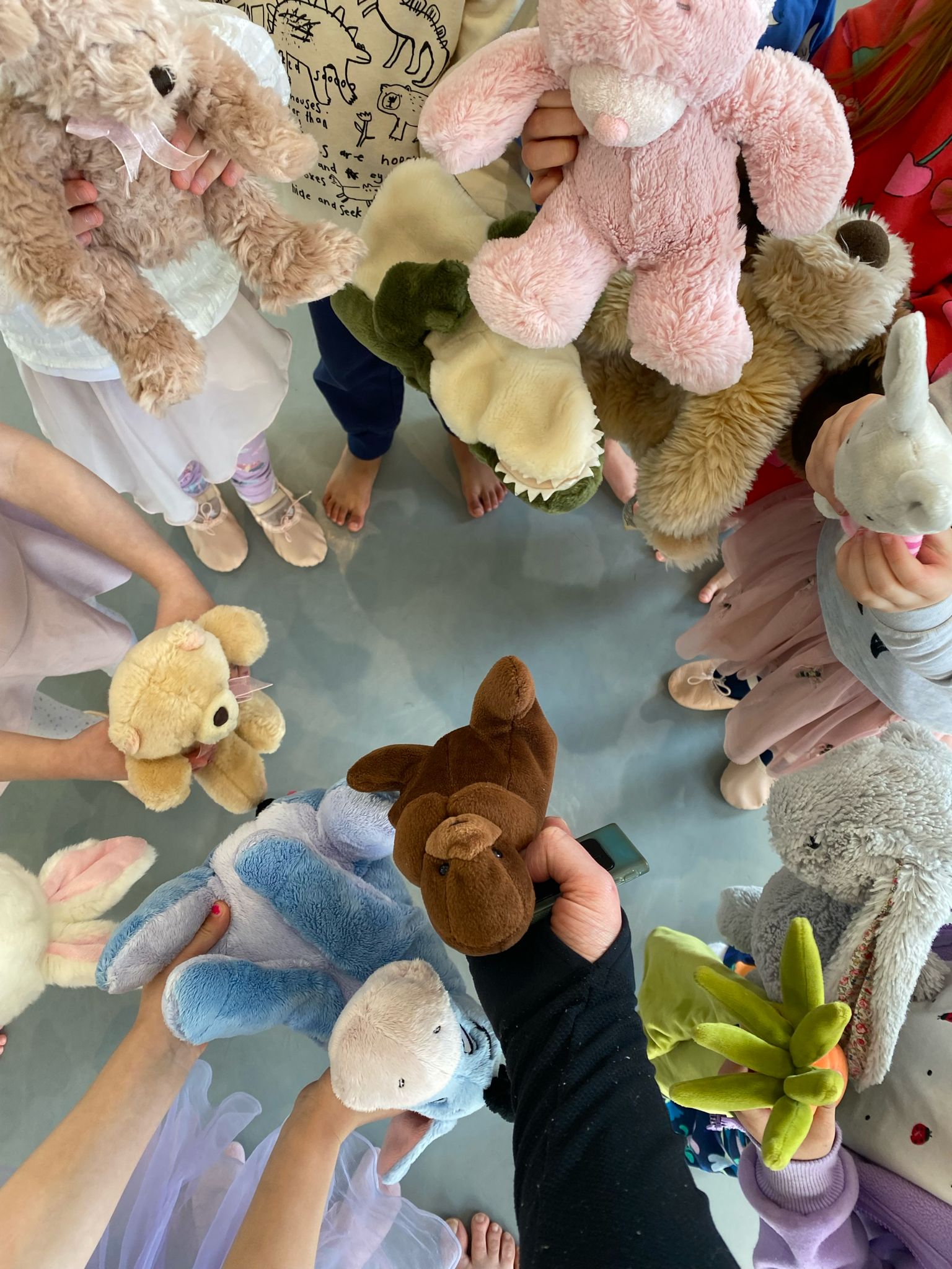 Children in a circle showing their teddy bears during a BDance class